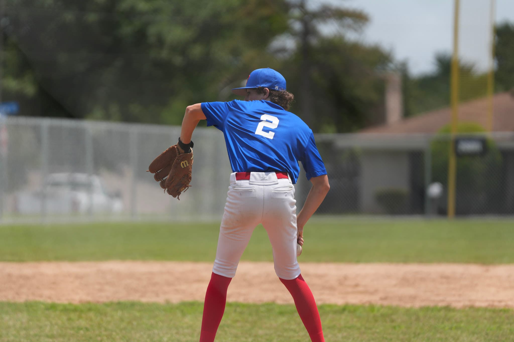 A Pistols Baseball infielder mid-throw during a game